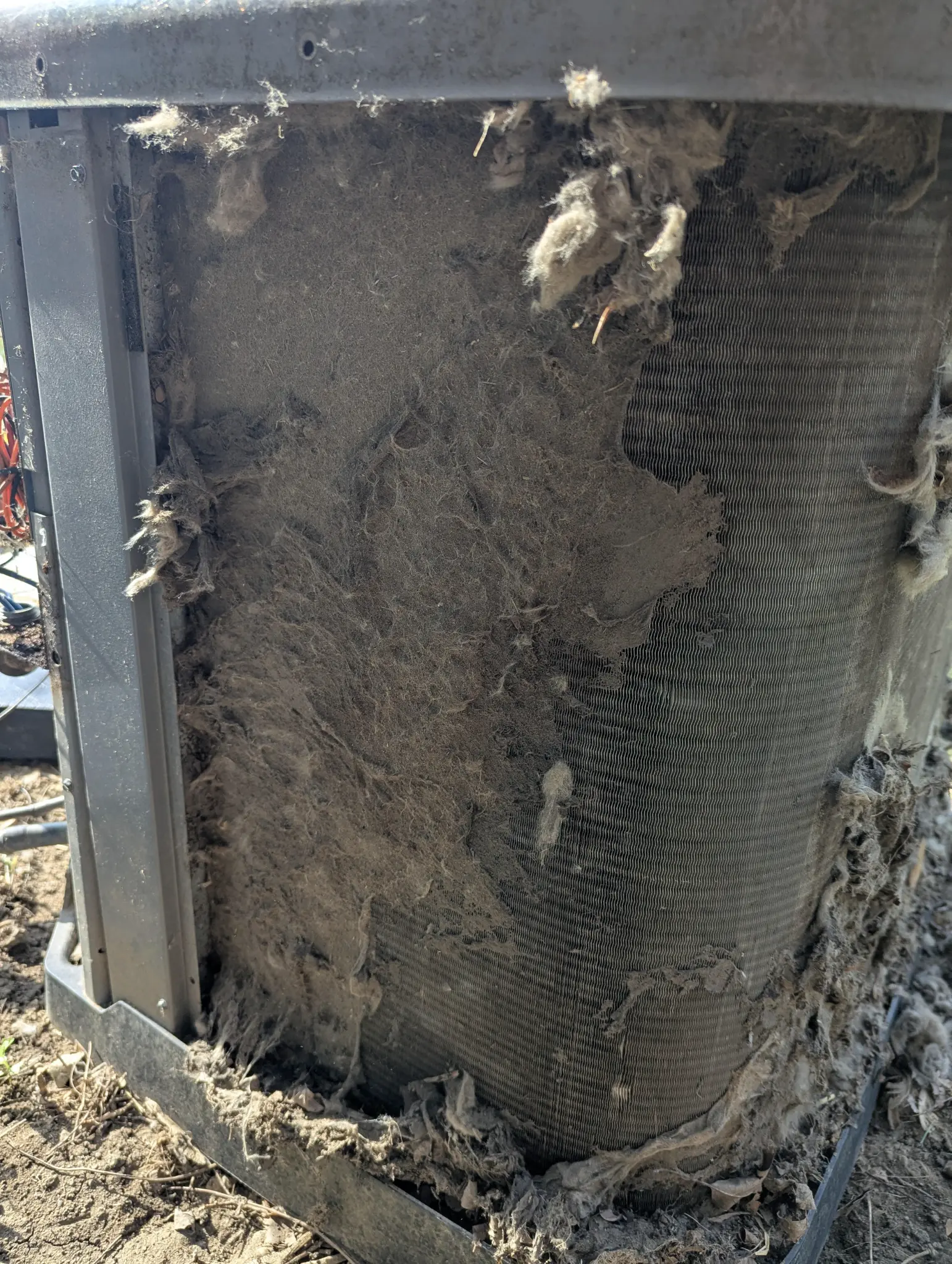 Visible HVAC coil surface with dust and debris