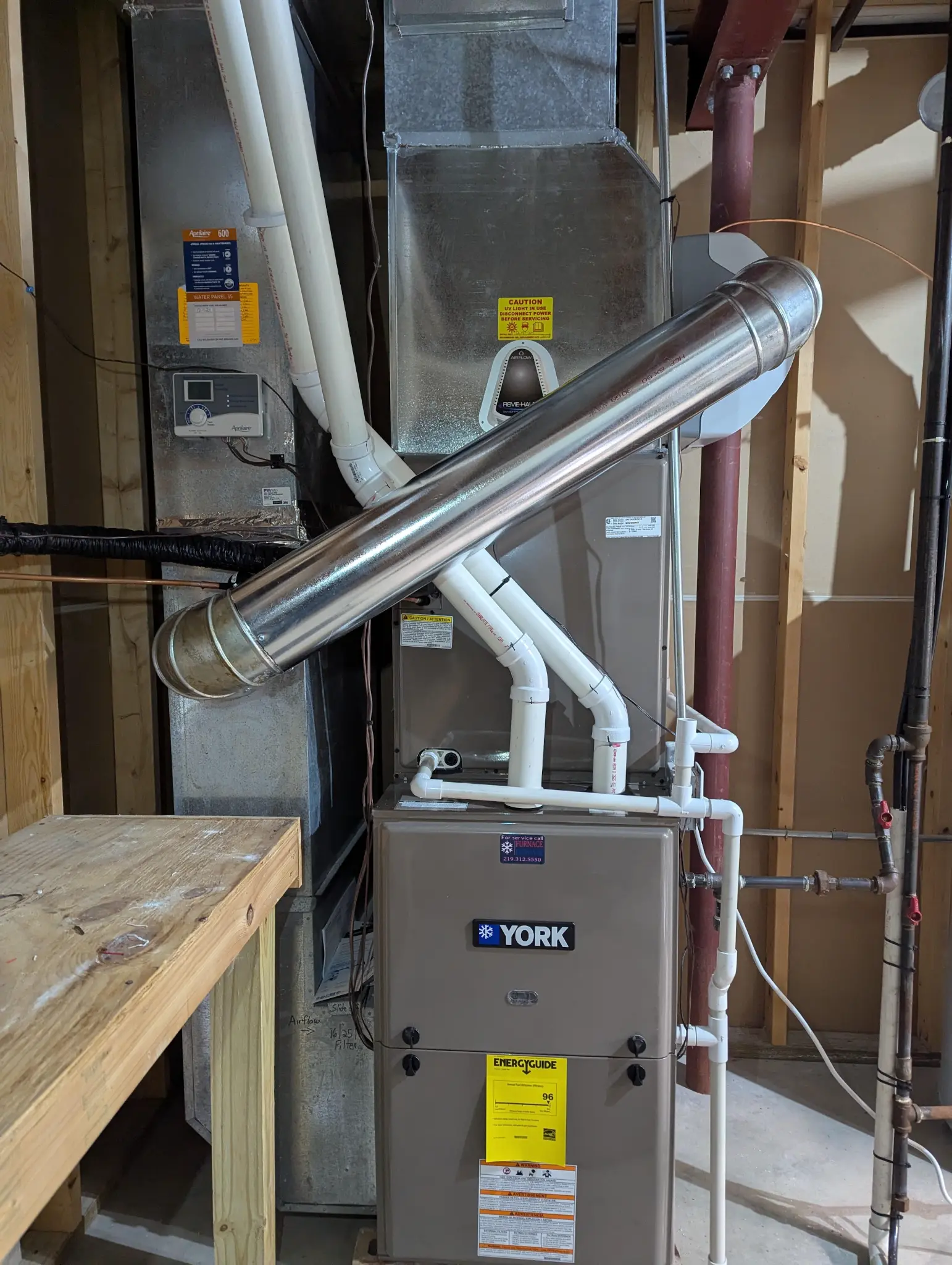 York furnace with visible venting and sheet-metal ductwork in a utility area